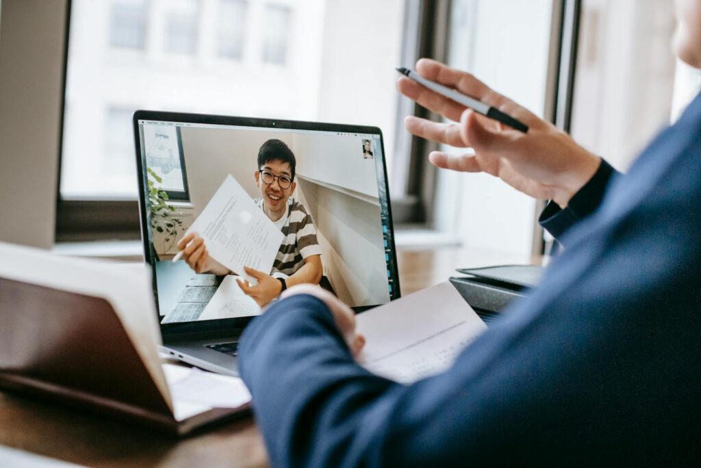 Two professionals engaged in a video conference showing office documents.